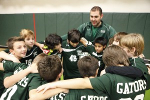 Student soccer players huddling together before a game