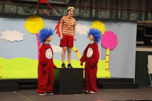 Three students act as Thing 1, Thing 2 and Conrad from the "Cat in the Hat" in a play adaptation of the book
