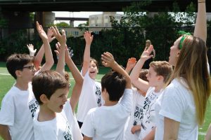 Students crowding together to cheer before an activity during Field Day