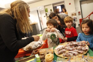 Parent talking to students during a PA Bake Sale