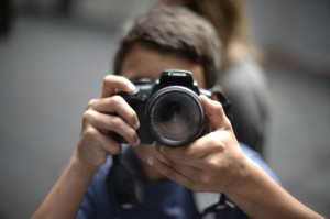 A student pointing a camera towards the viewer