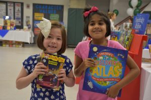 Two students with their new books from the Book Fair
