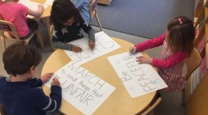 Students created protest signs using the "big words" they learned.