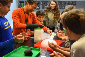 Students looking at a bubble of gas in science class