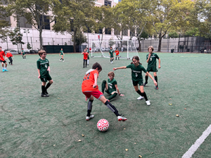 Gaynor soccer team playing in green jerseys against another soccer team in red jerseys