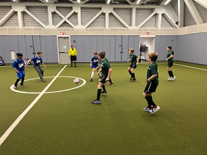 Gaynor soccer players on the field getting ready to kick the ball