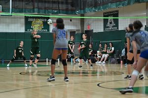 Gaynor volleyball player passes the ball as other players watch from behind