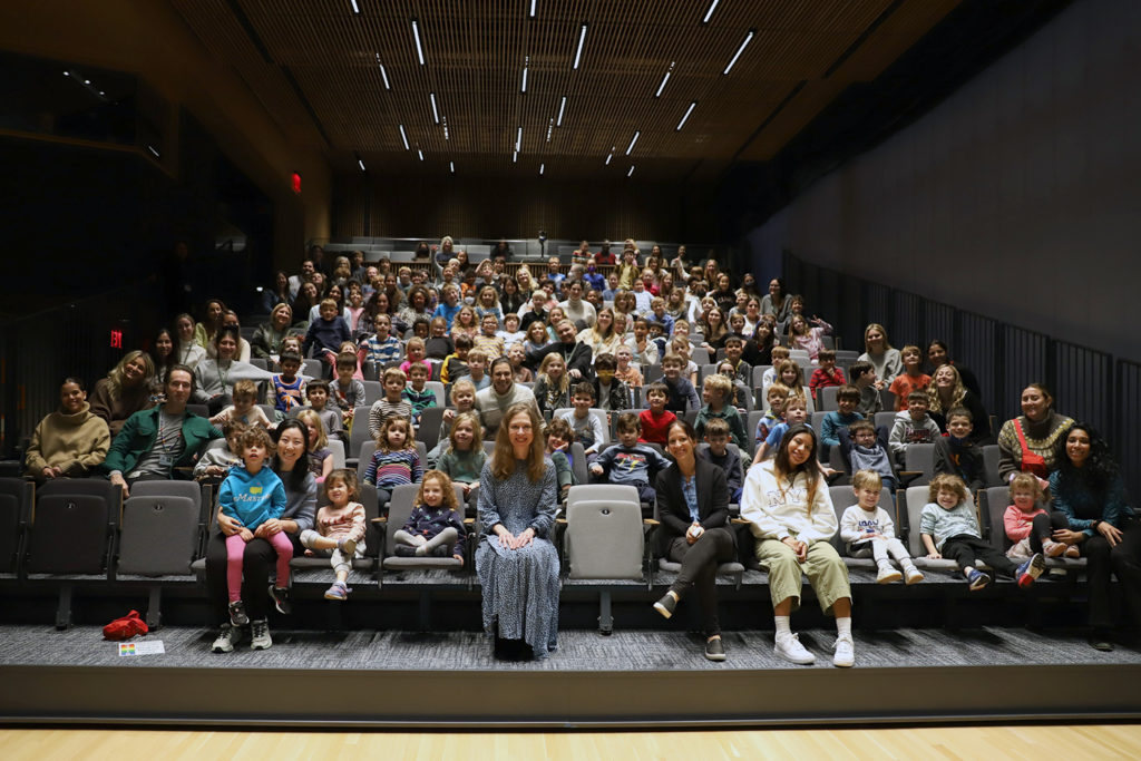 Chelsea Clinton (front, center) with students in the Purple, Pink, Red, and Orange Clusters.