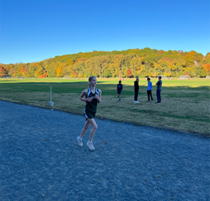 Member of Gaynor's girls cross-country team running on the track during a meet