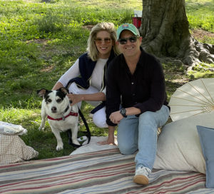Two adults and a small dog on a picnic in Central Park