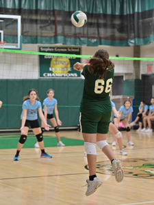 Gaynor volleyball player bumps the ball up into the air