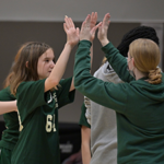 Gaynor volleyball player high-fives her coach