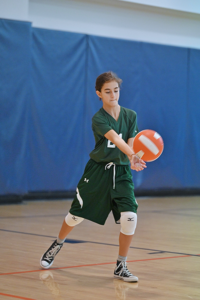 Gaynor volleyball player with arms reached out, receiving the ball