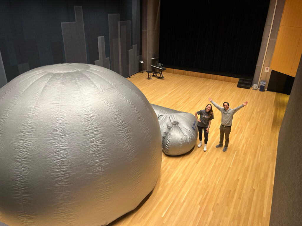 Ms. Grady and Mr. Prasarn pose together outside of the StarLab.