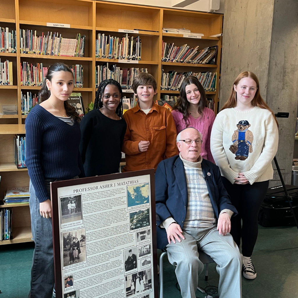 Students pose with the Holocaust survivor with whom they worked on Names, Not Numbers