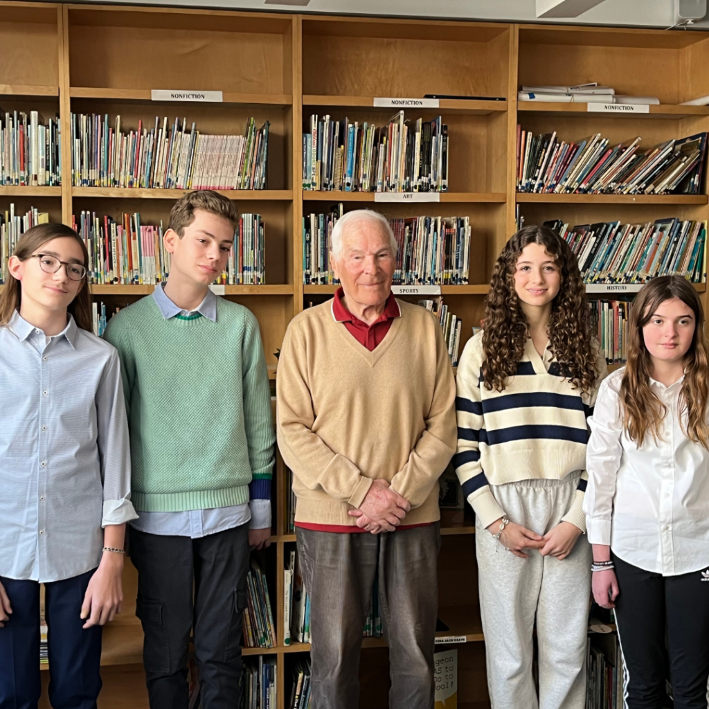 Students pose with the Holocaust survivor with whom they worked on Names, Not Numbers