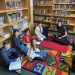 Gaynor students with R.E.A.D. Therapy Dog Arrow and her owner, Susan.
