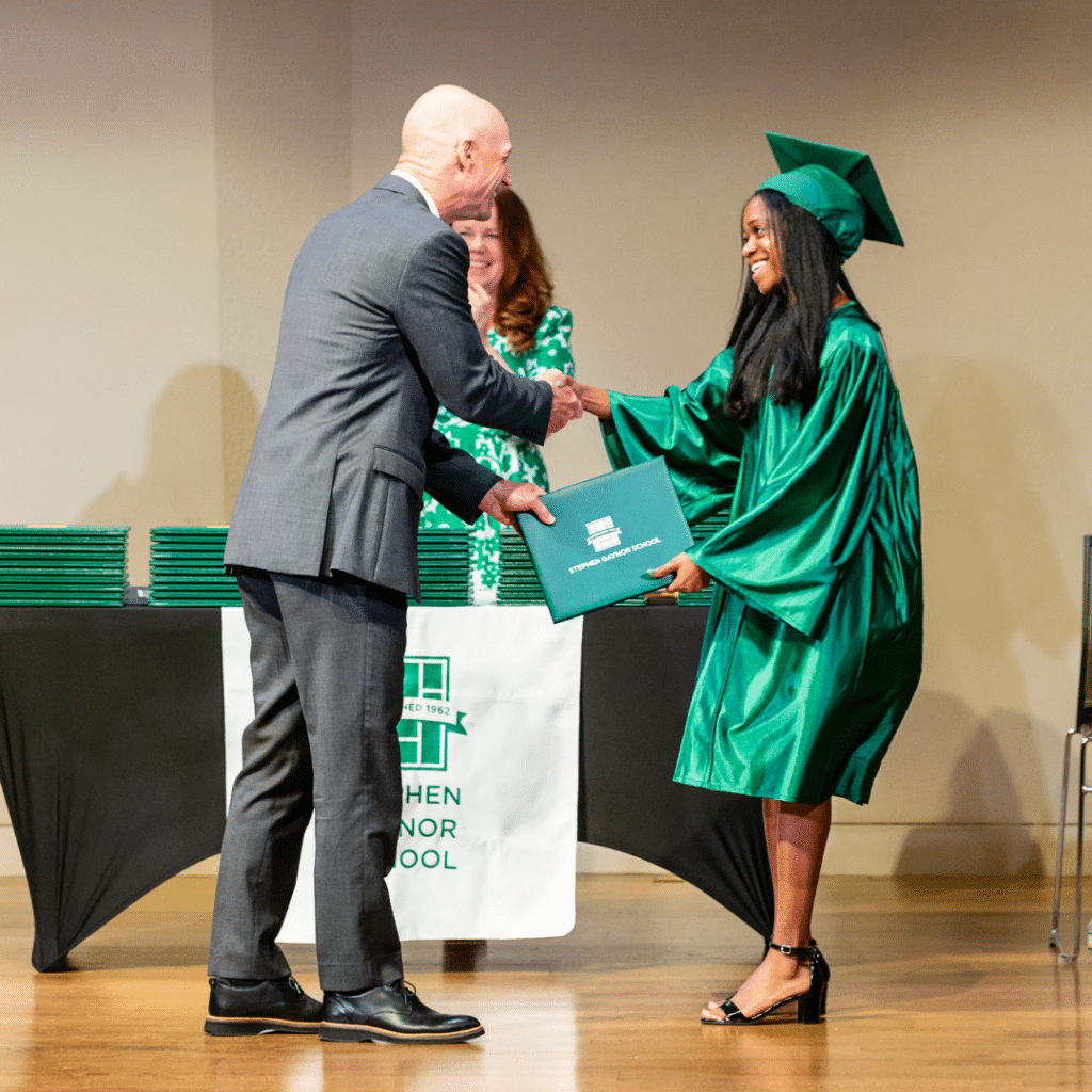 Dr. Gaynor hands diploma to a graduate