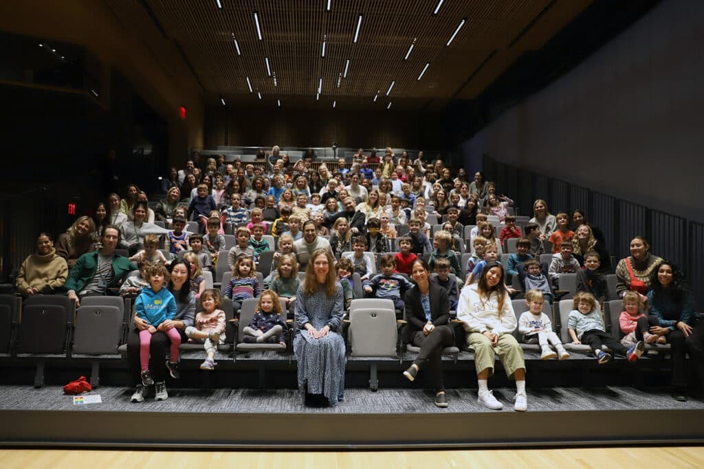 Chelsea Clinton (front, center) with students in the Purple, Pink, Red, and Orange Clusters.