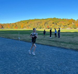Member of Gaynor's girls cross-country team running on the track during a meet