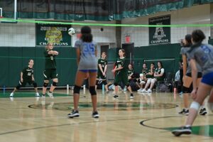 Gaynor volleyball player passes the ball as other players watch from behind